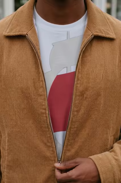 White T-Shirt Mockup Under a Corduroy Jacket