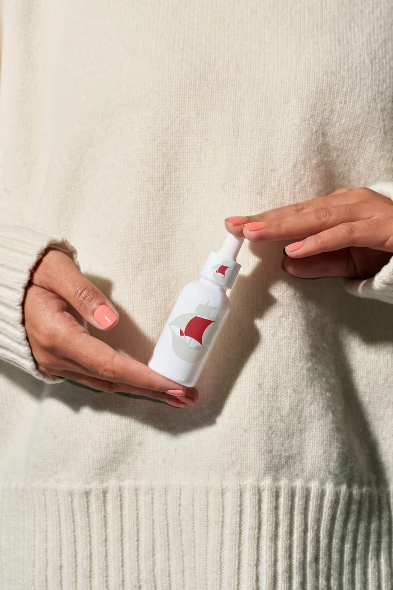 Dropper Bottle Mockup Held Against Cream Knit