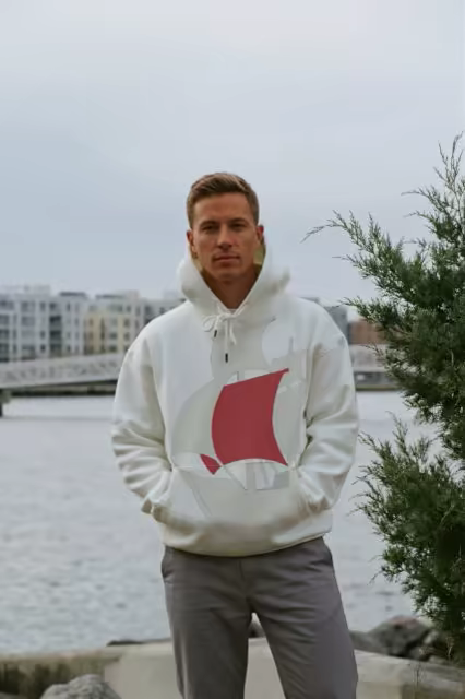White Hoodie Mockup Worn by a City Harbor