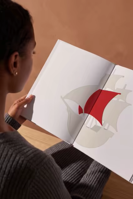 Hardcover Book Mockup Against a Clay Wall