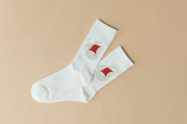 White Crew Socks Mockup on a Sand Backdrop