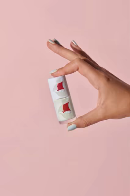 Cosmetic Jar Mockup Held on a Pink Backdrop