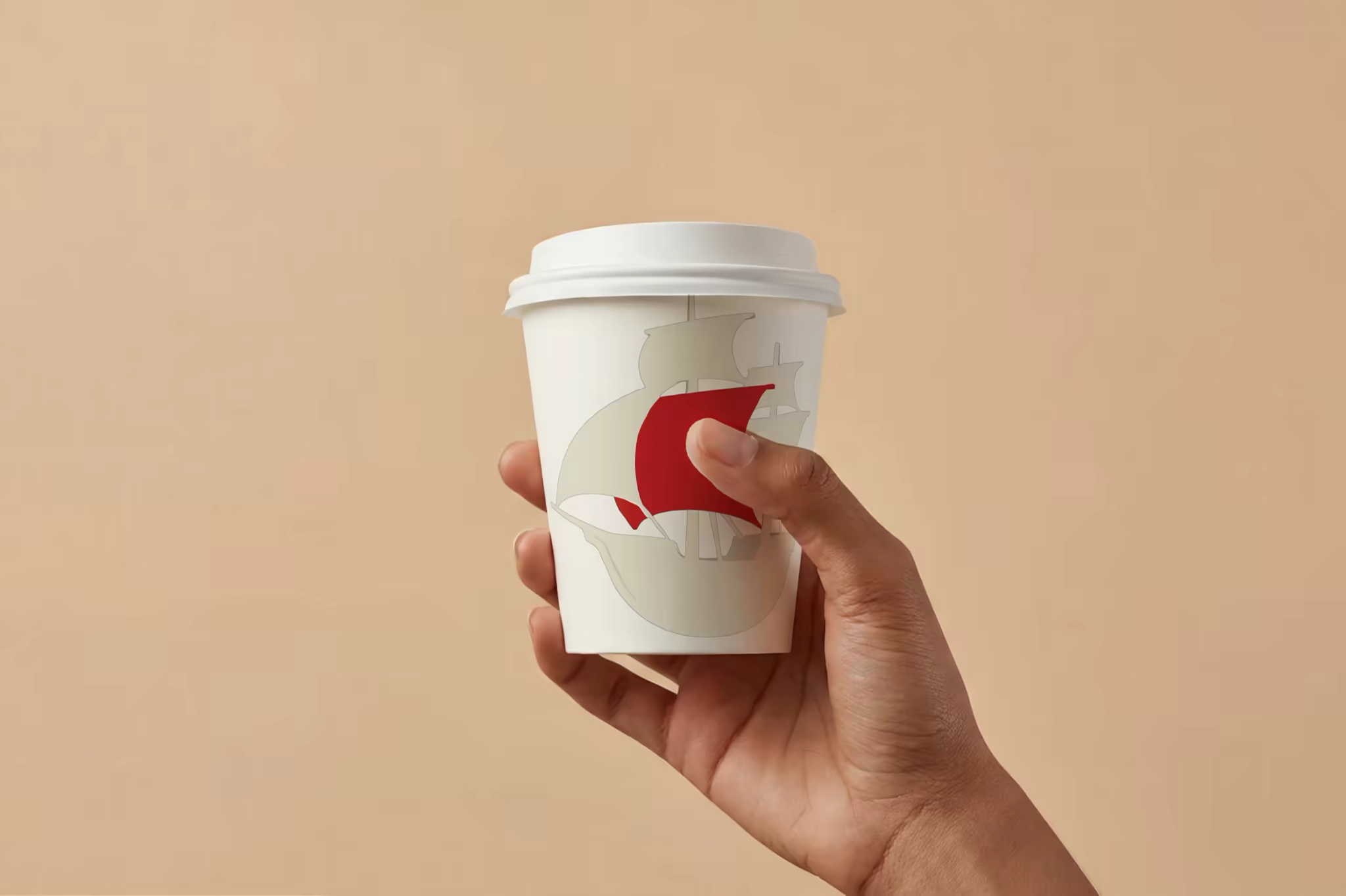 Paper Coffee Cup Mockup Held on Warm Beige