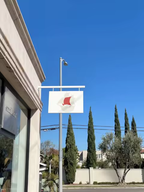 Projecting Shop Sign Mockup Under a Blue Sky