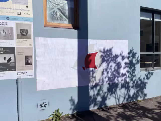 Wheatpaste Poster Mockup on a Blue Facade