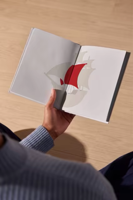 Open Book Mockup Held Above an Oak Floor