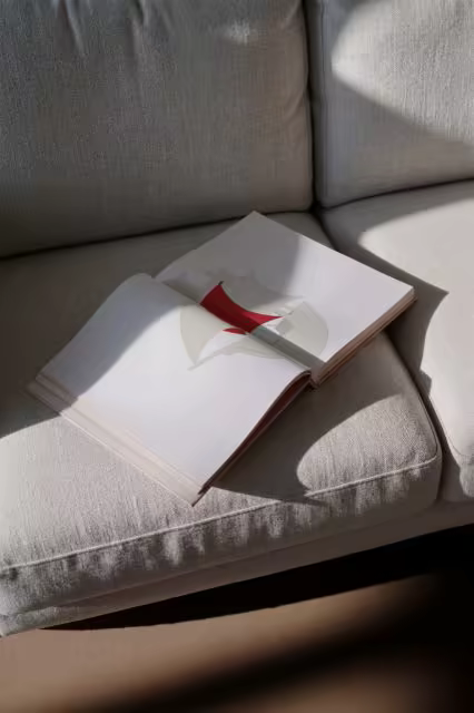 Softcover Book Mockup Open on a Linen Sofa