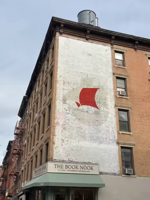 Faded Wall Mural Mockup Above a Bookshop Awning
