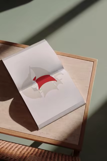 Open Hardcover Mockup on a Wooden Side Table