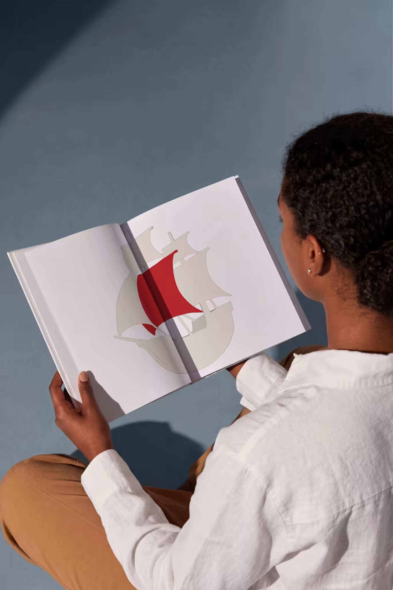 Hardcover Mockup Held Open by a Reader in Linen