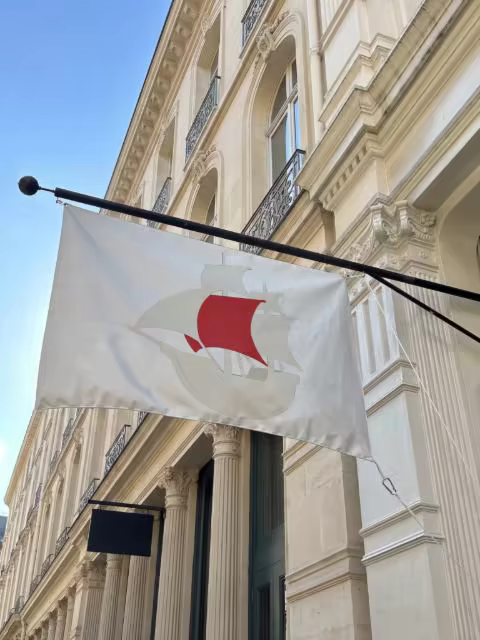 Fabric Flag Mockup on an Ornate Stone Facade