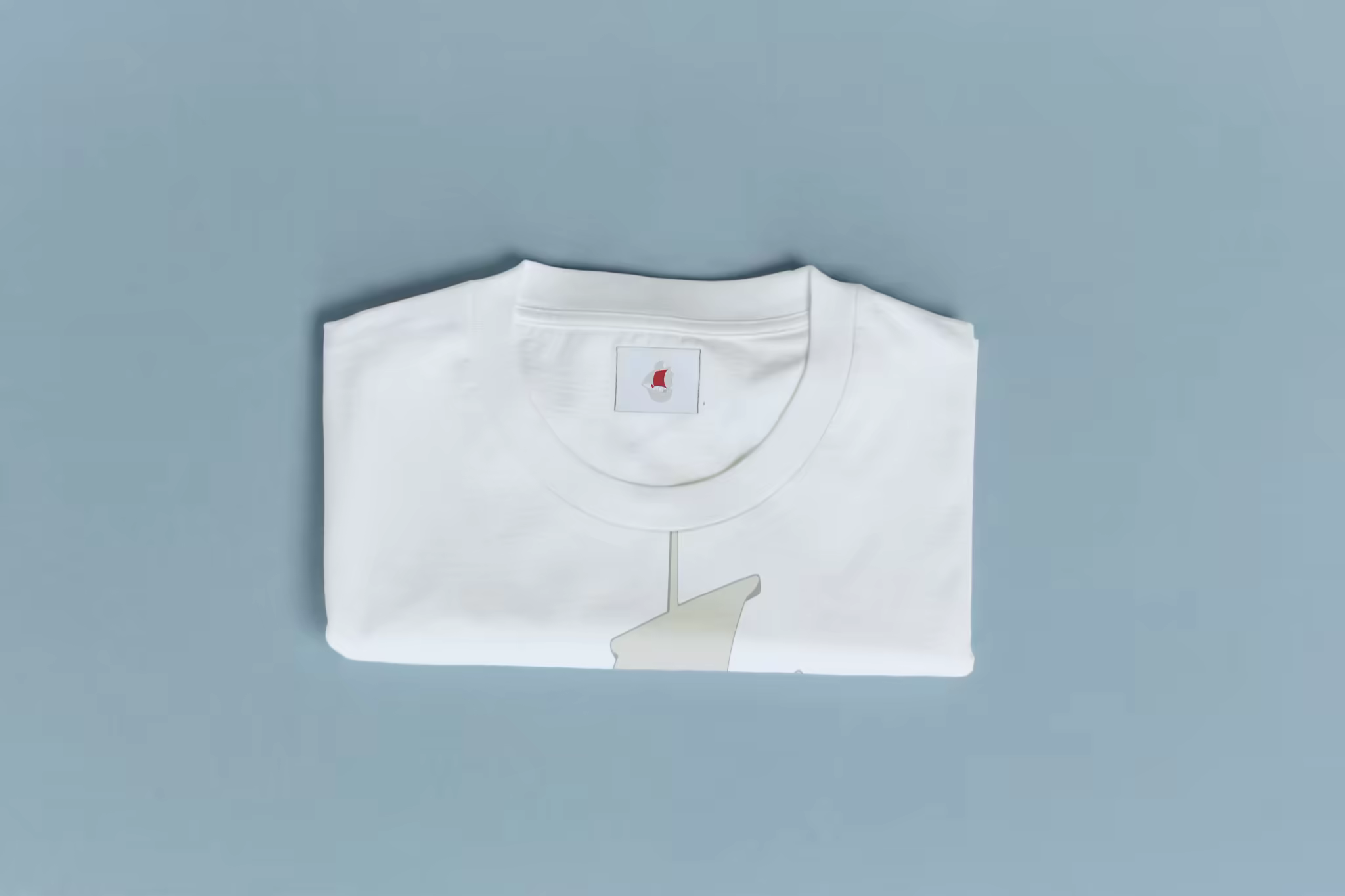 Folded T-Shirt Mockup on a Cool Blue Backdrop